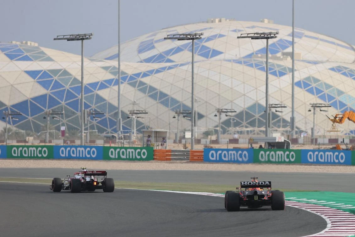 Alfa Romeo’s Italian driver Antonio Giovinazzi and Red Bull’s Mexican driver Sergio Perez drive during the first practice session ahead of the Qatari F1 Grand Prix at the Losail International Circuit on Friday. (AFP)