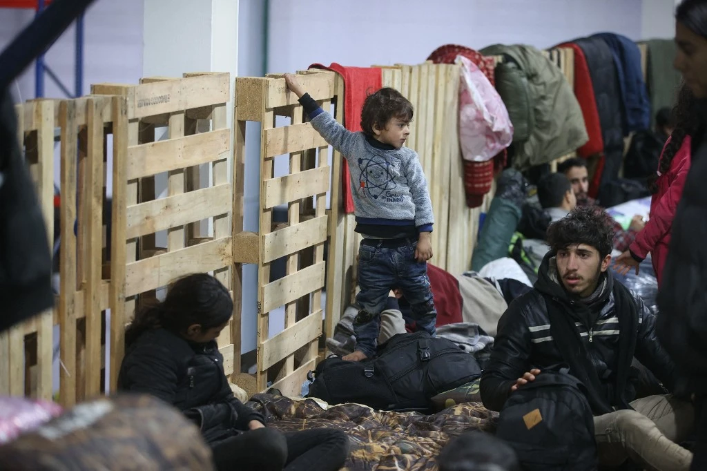 Migrants stay in the transport and logistics centre near the Bruzgi border point on the Belarusian-Polish border in the Grodno region on November 18, 2021. (FIle/AFP)