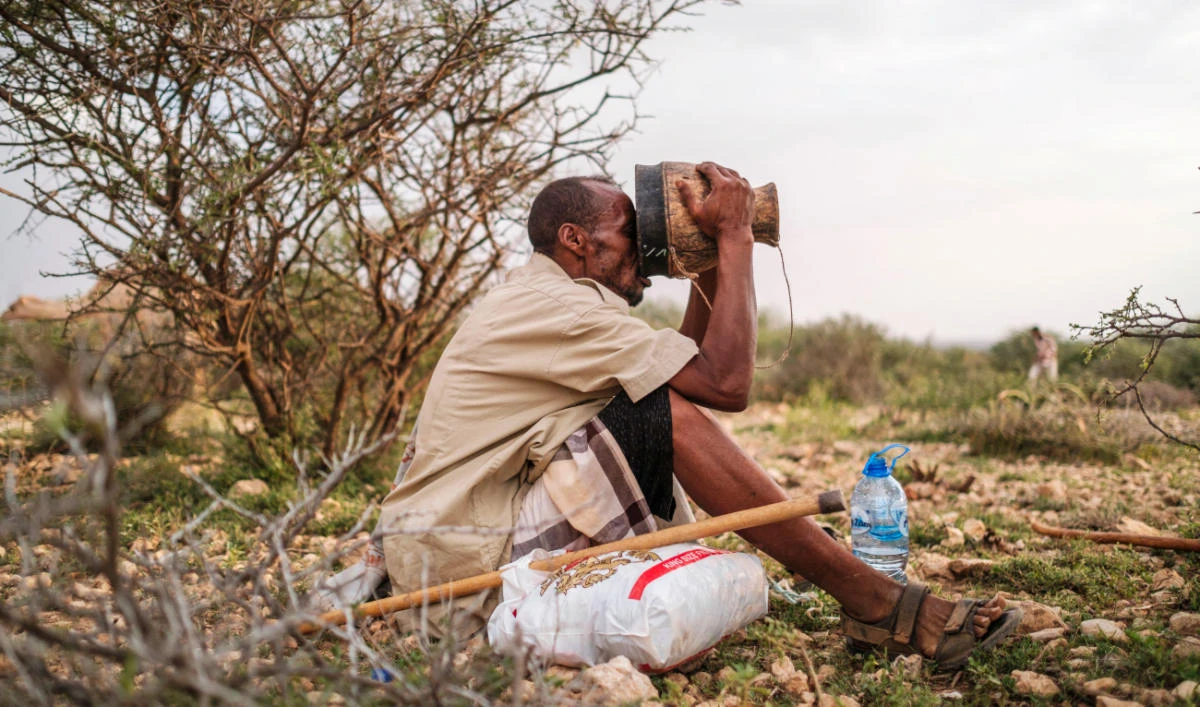 Ali Abdi Elmi drinks from a cup filled with camel milk, in the outskirts of the city of Hargeisa, Somaliland. (AFP)
