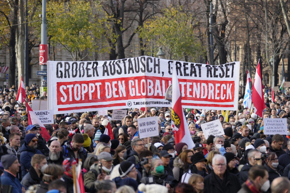 Protesters with a banner reading ‘Great exchange, Great Reset, Stop the globalist filth’ attend a demonstration against measures to battle the coronavirus pandemic in Vienna on Saturday. (AP)