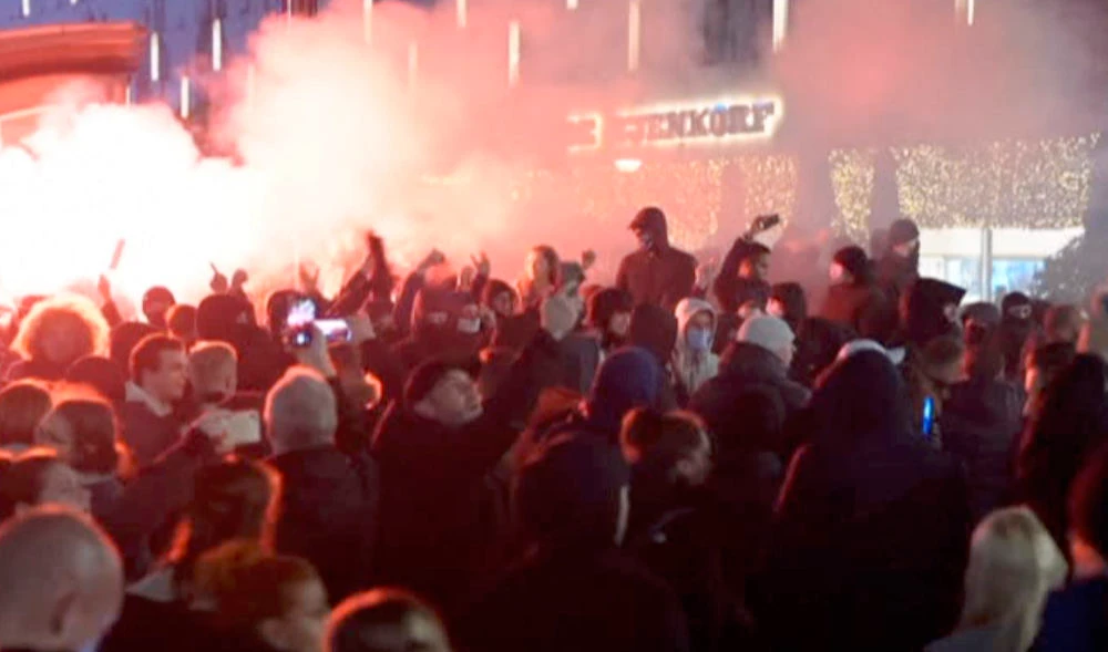 In this image taken from video, demonstrators protest against government restrictions due to the coronavirus pandemic, Friday, Nov. 19, 2021, in Rotterdam, Netherlands. (AP)