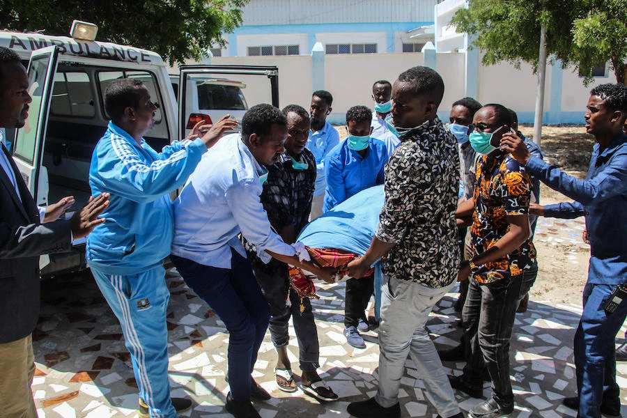 Family members carry the body of Abdiaziz Mohamud Guled, the director of government-owned Radio Mogadishu. (AFP)
