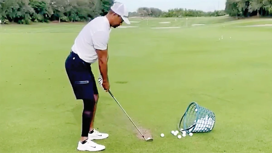 A screen grab from Tiger Woods’ post on Twitter of his first video taking practice swings since the car accident in February. (CNN)