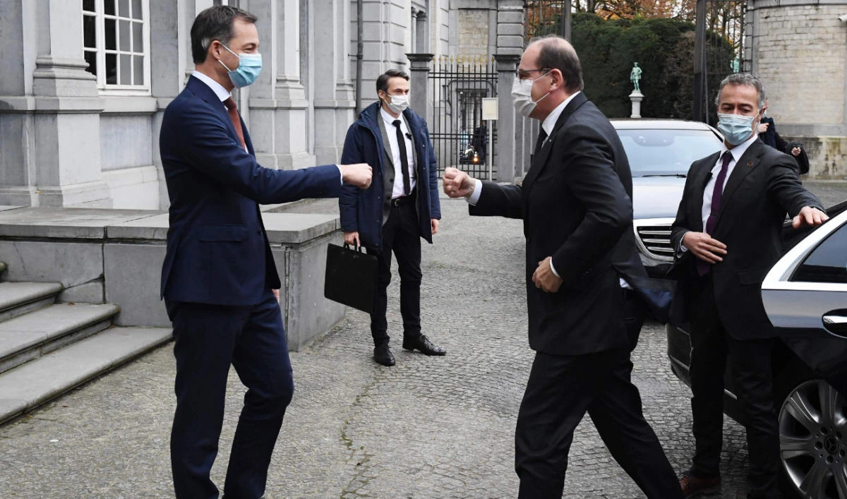 Belgian Prime Minister Alexander De Croo (L) welcomes his French counterpart Jean Castex (R) before a meeting in Brussels, on November 22, 2021. (AFP)