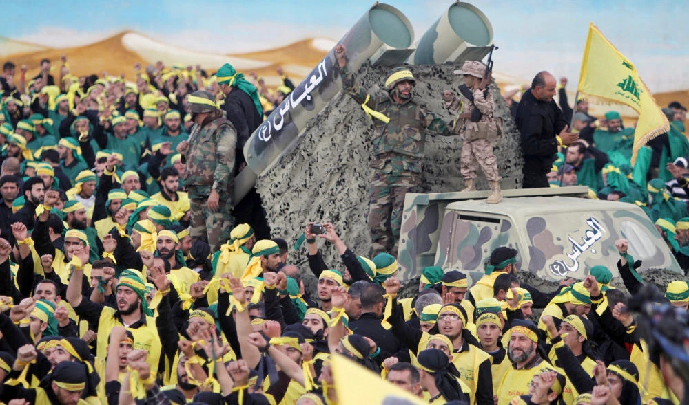 Hezbollah fighters stand atop a truck mounted with mock rockets during a rally in Nabatiyeh, Lebanon. (AP file photo)