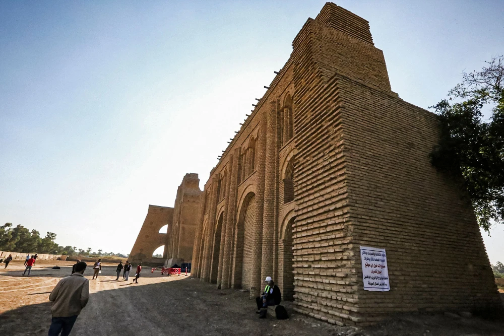 This picture taken on November 24, 2021 shows a lateral view of the Arch of Ctesiphon, also known as Taq Kisra (Khosrow's Arch), stands before the conservators' scaffolding at the ancient site of Ctesiphon near moden al-Madain in central Iraq. (AFP)