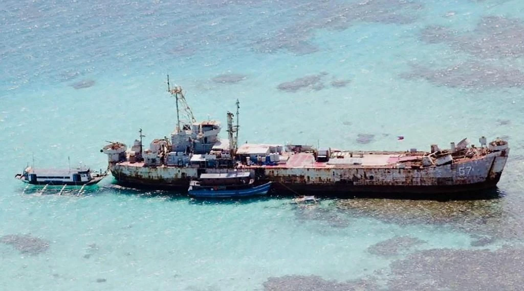 Above, two civilian supply boats anchored at BRP Sierra Madre, which the Philippines intentionally grounded at the Second Thomas shoal in 1999, in this photo released on Nov. 24, 2021. (Department National Defense Philippines/AFP)