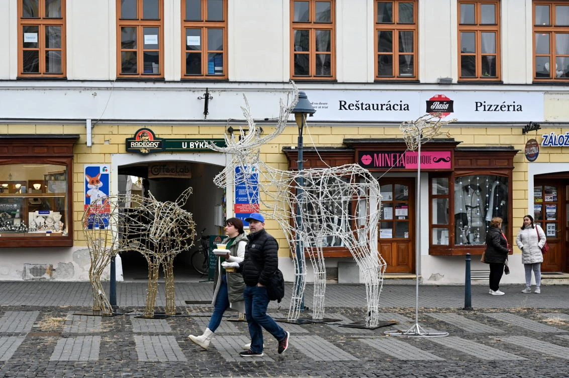 People walk past closed restaurants as the Slovak government mandated further restrictions to curb the spread of COVID-19 in Trencin, Slovakia on Thursday. (Reuters)