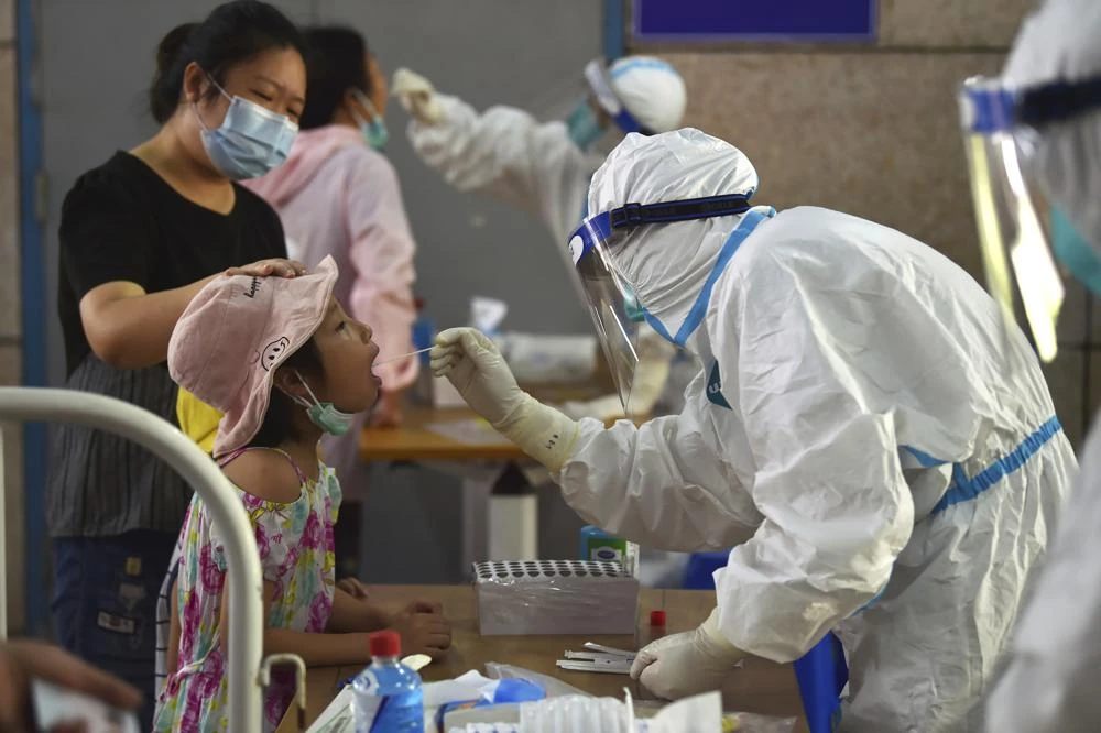 A nurse takes swab samples in the new rounds of Covid-19 testing in Nanjing in eastern China's Jiangsu province Monday, Aug. 2, 2021. (AP)