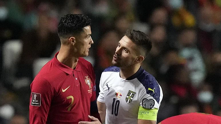 Portugal's Cristiano Ronaldo, left, with Serbia's Dusan Tadic during the World Cup 2022 group A qualifying football match in Lisbon, Nov 14, 2021. (AP)