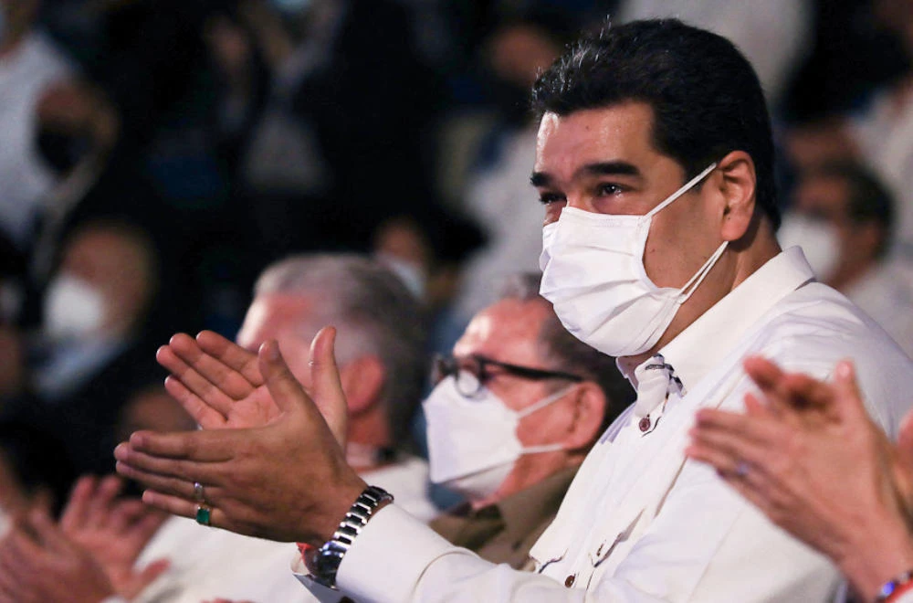 Venezuela's President Nicolas Maduro (R) applauding next to former Cuban President Raul Castro (L) during the inauguration ceremony of the Fidel Castro Ruz Center in Havana, on November 25, 2021. (AFP)