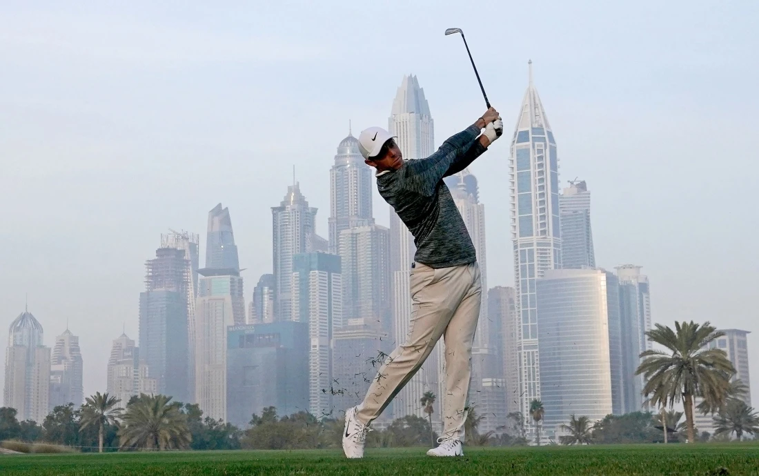 Rory McIlroy of Northern Ireland plays his second shot on the par 5, 13th hole during the Dubai Desert Classic at Emirates Golf Club in 2018. (David Cannon/Getty Images)