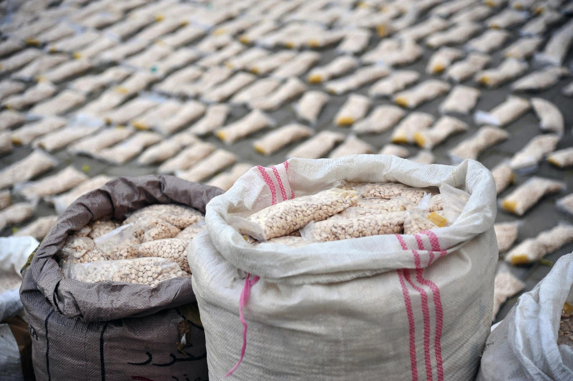 In this photo released by the Syrian official news agency SANA, Syrian authorities display Captagon pills, in rural Damascus, Syria, Tuesday, Nov. 30, 2021. (AP)