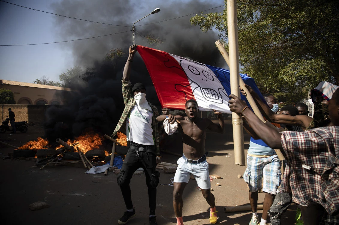 Protesters, displaying a French flag with skull and crossbones, take to the streets of Burkina Faso’s capital Ouagadougou, Nov. 27, 2021, calling for President Roch Marc Christian Kabore to resign. (AP Photo)