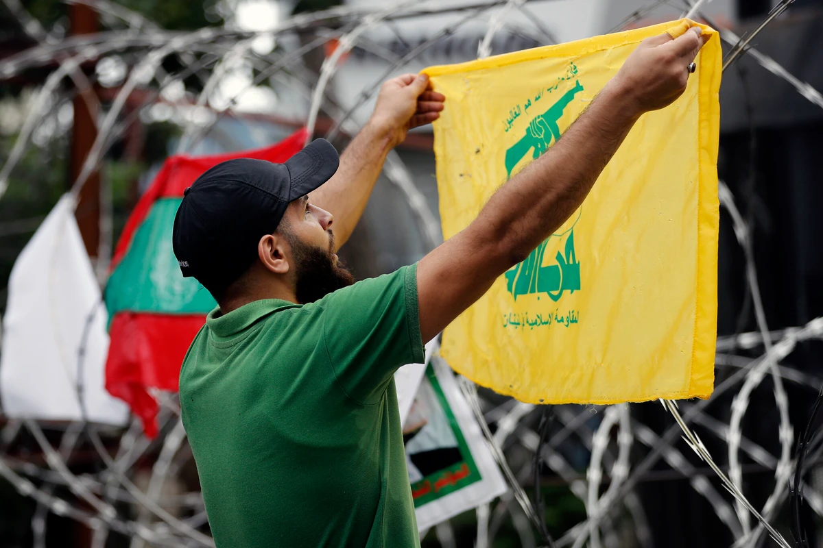 A Hezbollah supporter protests US involvement in Lebanon’s affairs, near the US embassy in Aukar, northeast of Beirut, Lebanon, July 10, 2020. (AP Photo)