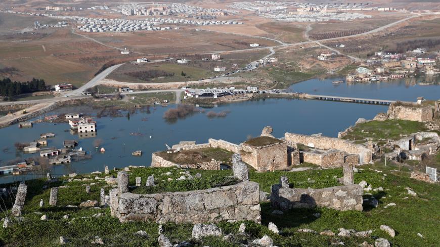 An old cemetery in Hasankeyf, which was submerged by the Ilisu Dam, with new Hasankeyf in the background, Batman, Turkey, Feb. 20, 2020. (Reuters)