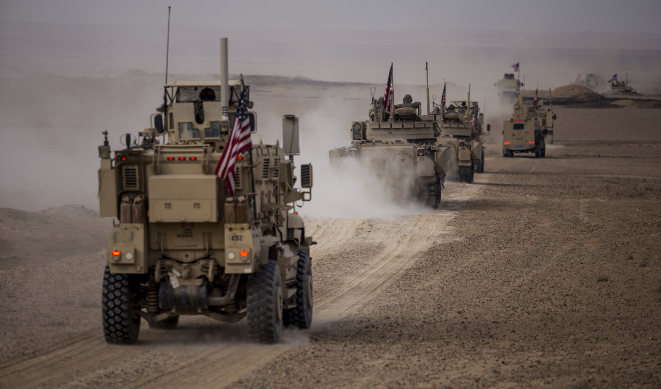 American military convoy rides during a joint exercise with Syrian Democratic Forces at the countryside of Deir Ezzor in northeastern Syria, Wednesday, Dec. 8, 2021. (AP)