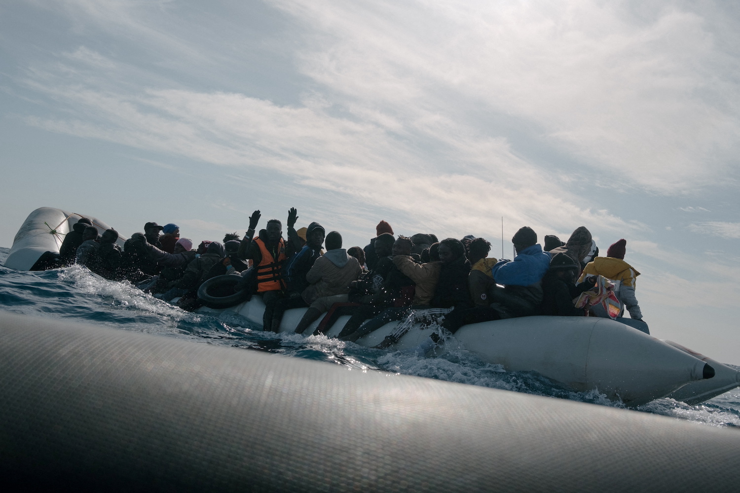 Migrants wait to be rescued by members of the German NGO Sea-Watch during a search and rescue (SAR) operation in the Mediterranean Sea, December 26, 2021. (Reuters)
