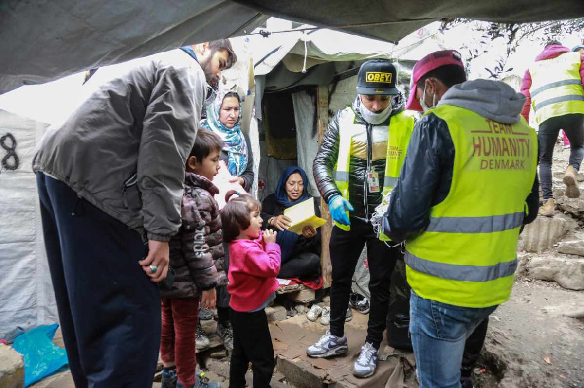 In this file photo taken on March 28, 2020 members of NGO "Team Humanity" shares protective face masks to refugees in the camp of Moria in the island of Lesbos in Greece. (Manolis Lagoutaris / AFP)