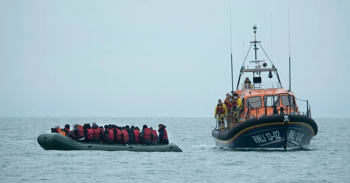 Migrants are approached by an RNLI lifeboat before being taken to a beach in Dungeness, on the southeast coast of England, Nov. 24, 2021. (AFP)