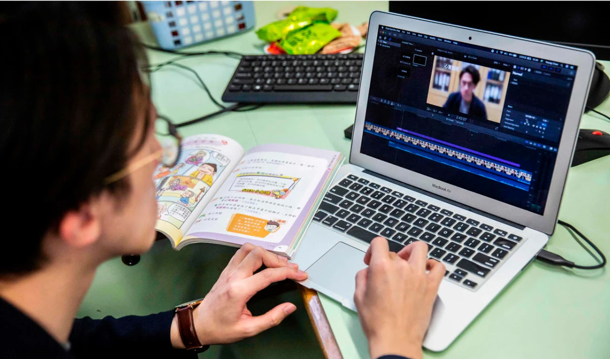 In this photo taken on March 6, 2020, primary school teacher Billy Yeung edits a video lesson he recorded in an empty classroom in Hong Kong. (AFP)