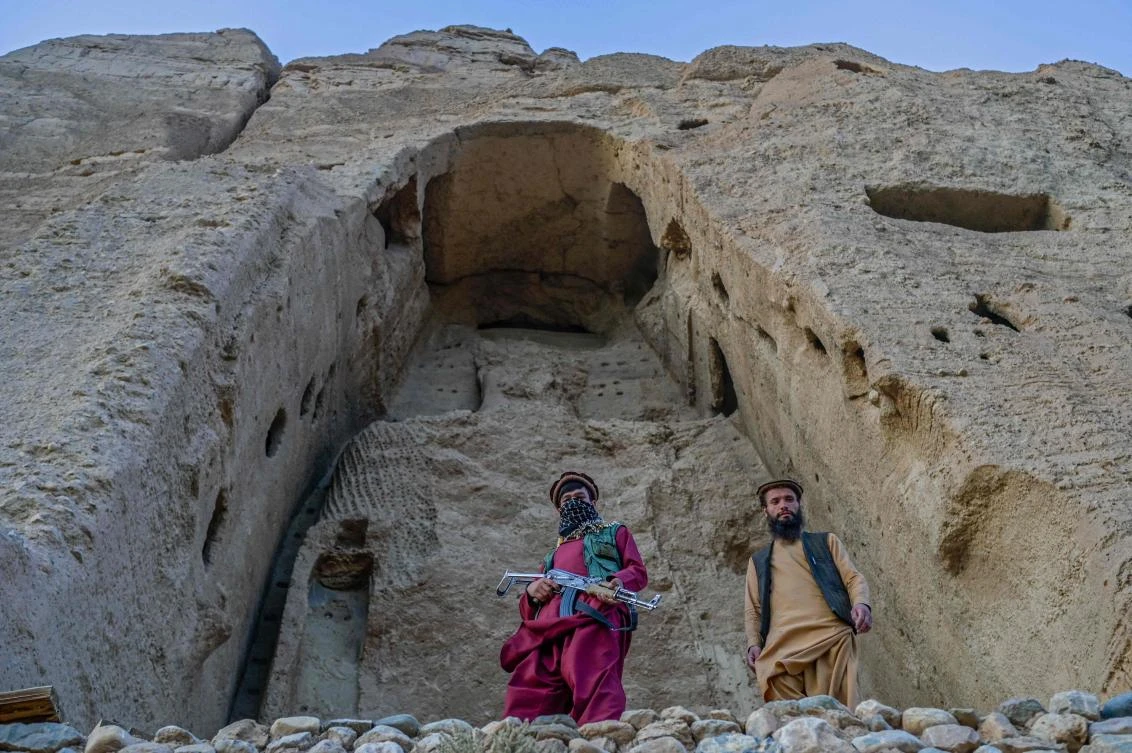 In this file photo taken on October 2, 2021, members of the Taliban stand in front of the site where the Shahmama Buddha statue once stood before being destroyed by the Taliban in March 2001, in Bamiyan province. (File/AFP)