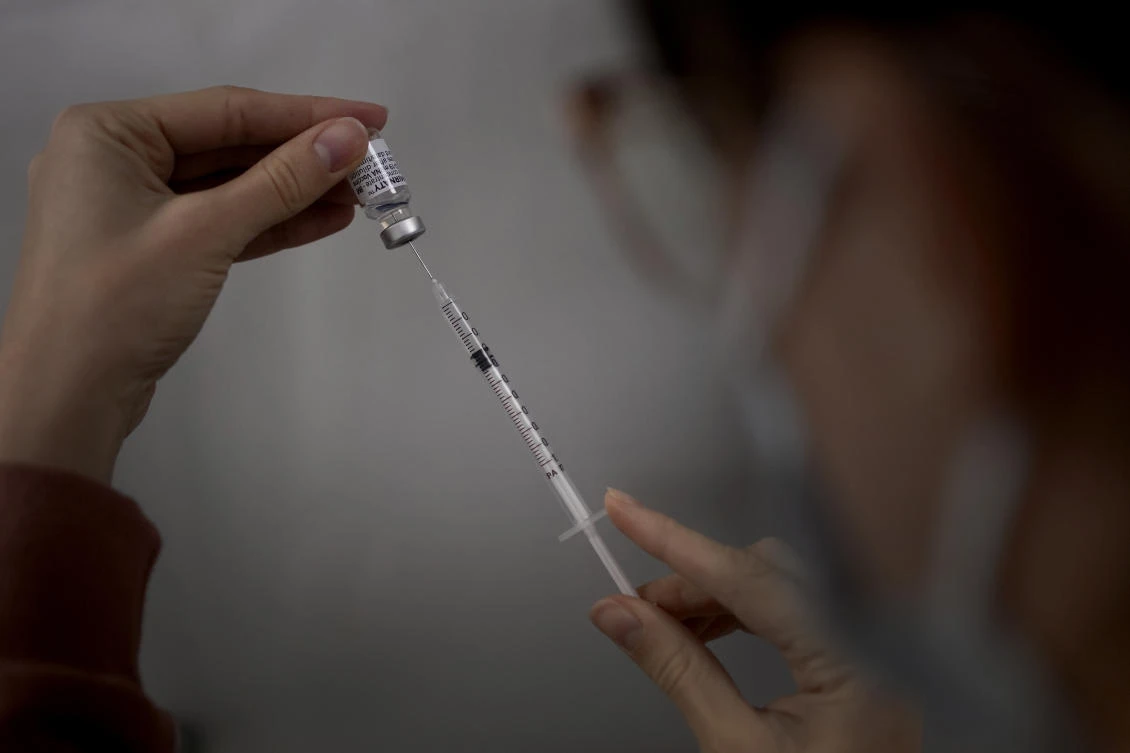 A medical staff prepares Pfizer’s COVID-19 vaccine. An official at WHO’s Eastern Mediterranean Regional Office said on Wednesday 7 countries in the region haven’t yet reached a threshold of 10 percent vaccination coverage. (AP)