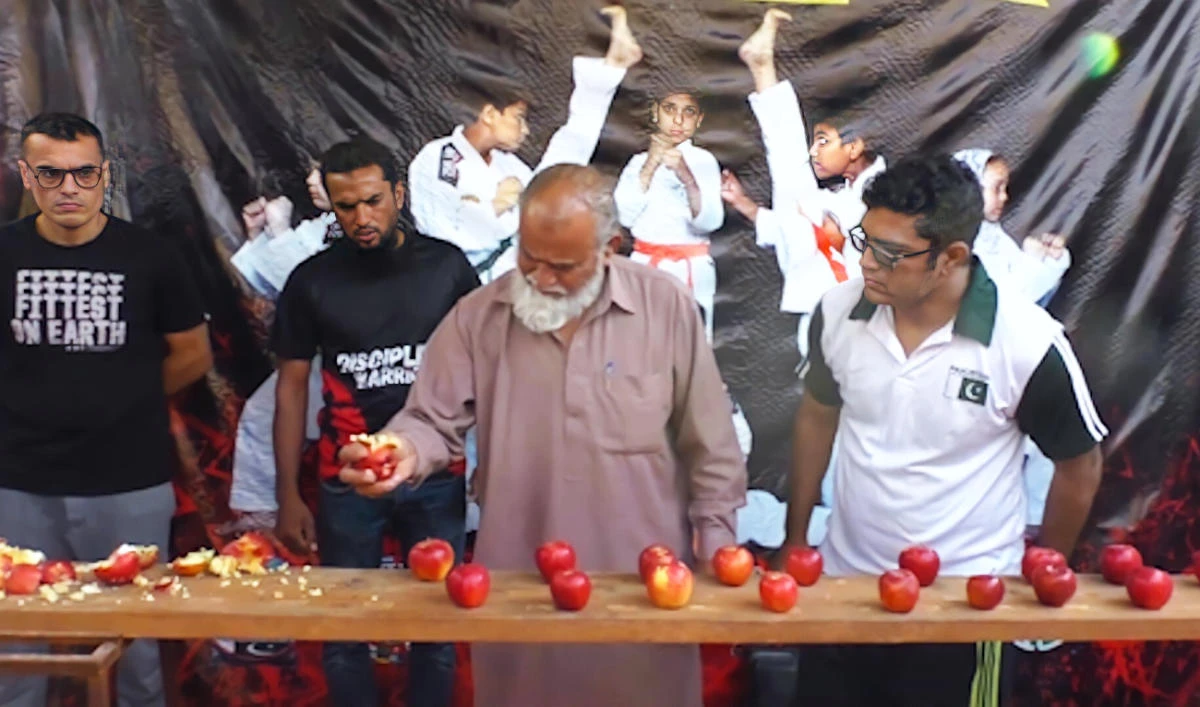 Naseem Uddin, 70, sets a Guinness world record for most apples crushed in the hand in one minute. (Photo courtesy: Mohammed Rashid)