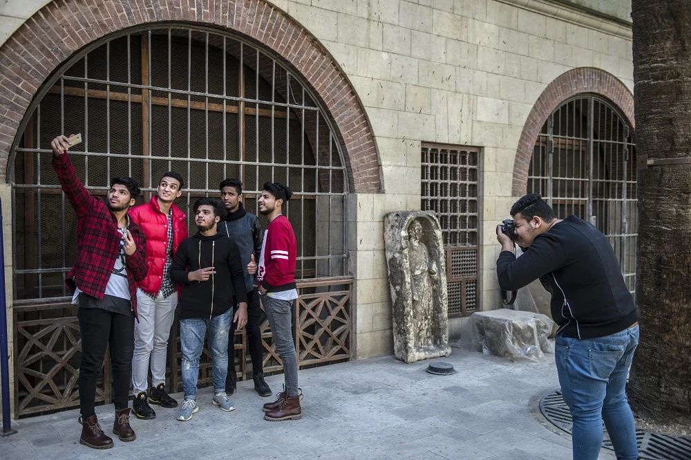 Hundreds of fashionable youngsters are a common sight in posh Cairo districts these days, carrying expensive cameras and trendy clothes in their backpacks -- ready to pose for a photo shoot wherever possible. (AFP/File Photo)