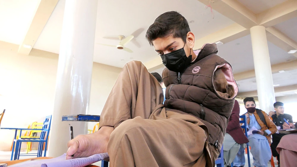 Born without arms but full of moxie, Pakistani boy excels at school and cricket