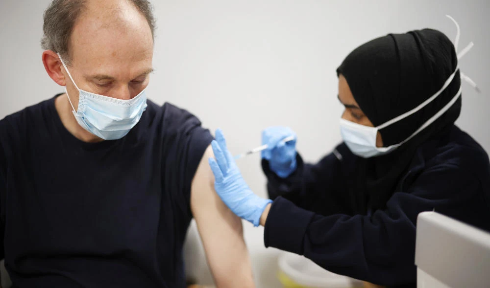 A person receives a dose of the Pfizer coronavirus disease (COVID-19) vaccine at a vaccination site at the Westfield shopping centre in London, Britain, December 3, 2021. (REUTERS)