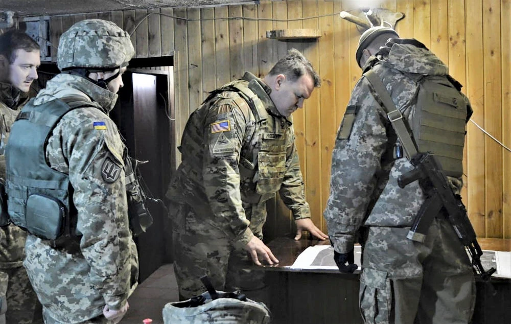 Attache of the Land Forces at the US Embassy in Ukraine Colonel Brandon Presley looks at the map during the visit by a delegation of the US Embassy in Ukraine. (AP file photo)