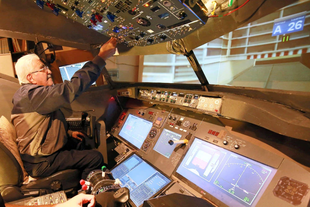 Muhammad Malhas, 76, operates his flight simulator cockpit at his home in Jordan's capital Amman on November 8, 2021. (AFP)