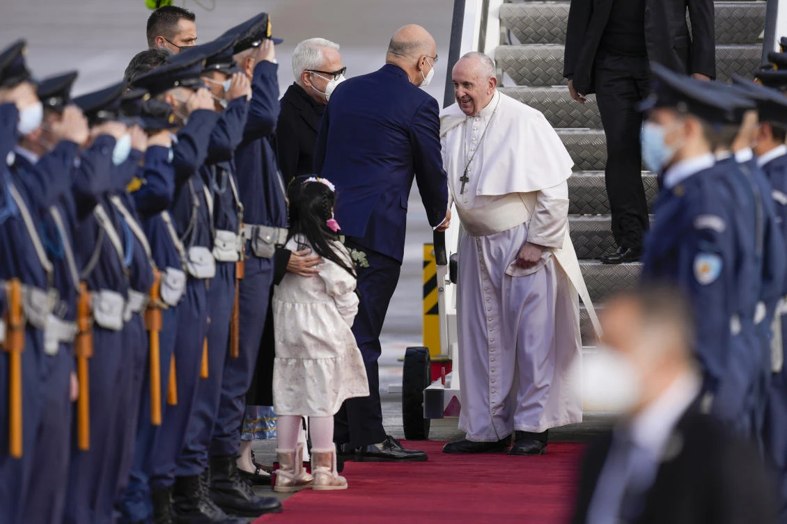 Pope Francis is greeted by Greek Foreign Minister Nikos Dendias as he arrives at the Eleftherios Venizelos International Airport in Athens, Greece, Saturday, Dec. 4, 2021. (AP)