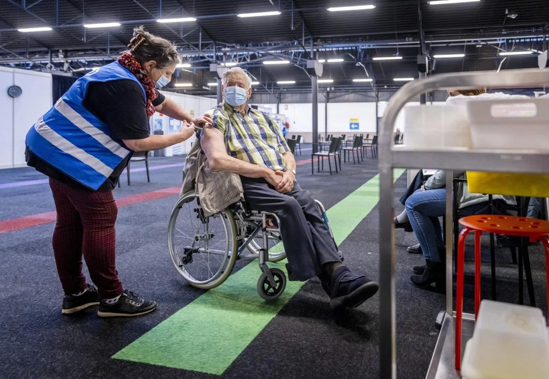 A GGD employee delivers a booster shot at a GGD (public health department) vaccination location in De Broodfabriek in Rijswijk, Netherlands on Friday. (AFP)