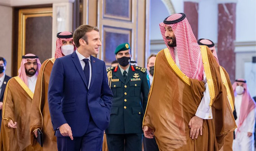 Saudi Crown Prince Mohammed bin Salman (R) walks with French President Emmanuel Macron (3rd from L) during his visit to Saudi Arabia on Dec 4, 2021. (SPA)
