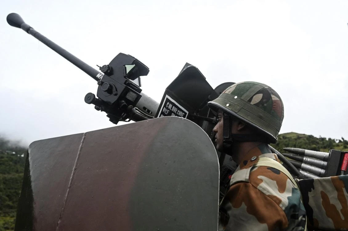 Indian Army soldier sits inside an upgraded L70 anti aircraft gun in Tawang, near the Line of Actual Control (LAC), in the northeast Indian state of Arunachal Pradesh on October 20, 2021. (File/AFP)