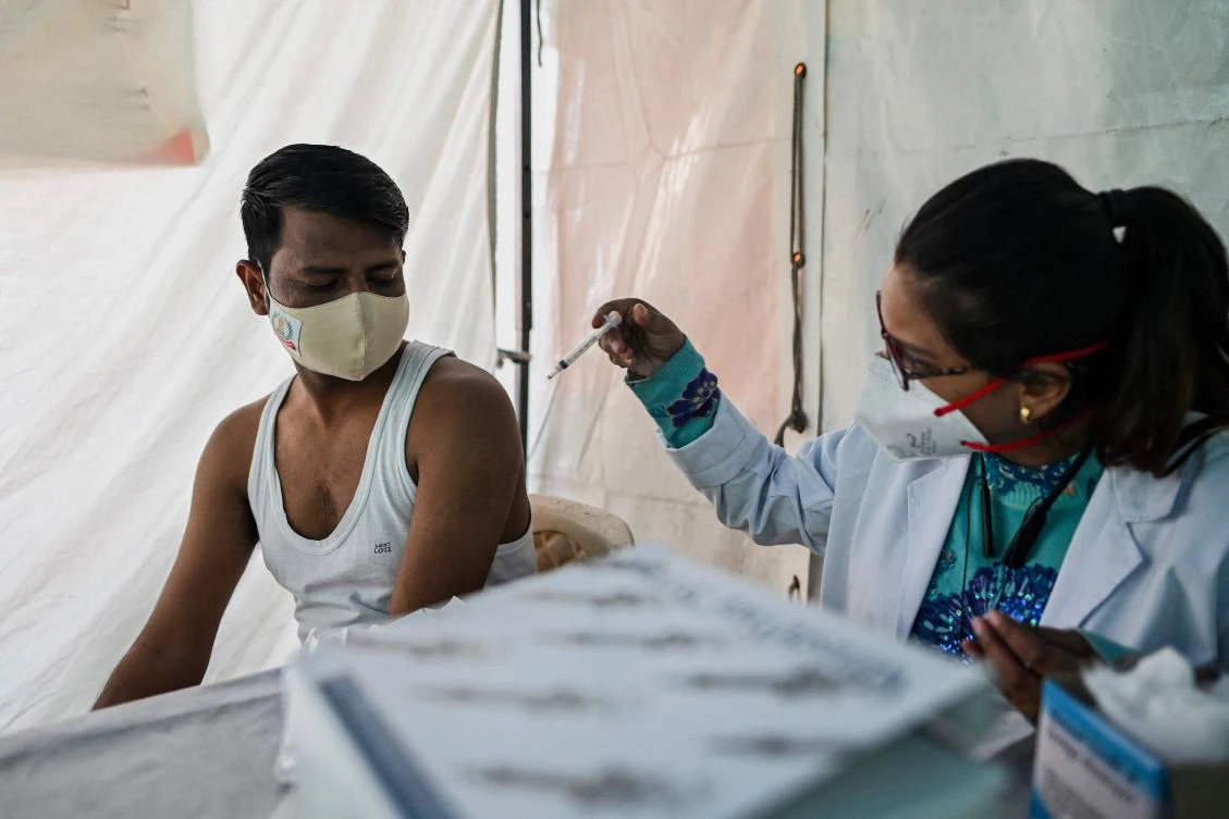 India has fully vaccinated 51 percent of its 944 million adults and given at least one dose to 85 percent. (AFP)