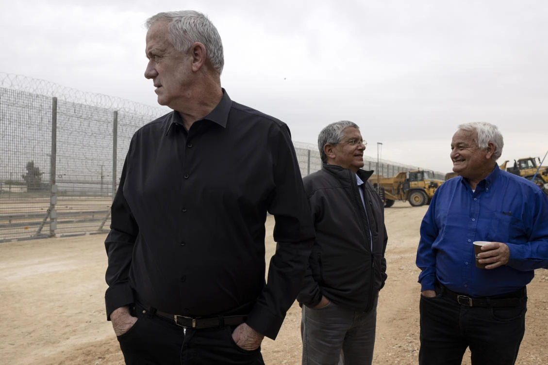 Israeli Defense Minister Benny Gantz, left, attends a ceremony marking the completion of the enhanced security barrirer along the Israel-Gaza border, Tuesday, Dec. 7, 2021. (AP Photo)