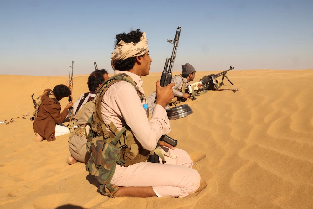 Pro-government tribal fighters take position in a desert area southeast of Marib, Yemen Dec. 6, 2021. (Reuters)