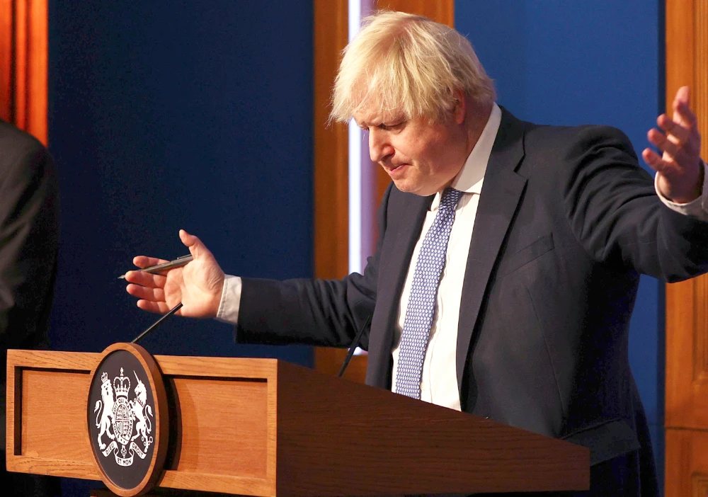 Johnson said it was time to impose stricter measures to prevent a spike of hospitalizations and deaths. (AP)