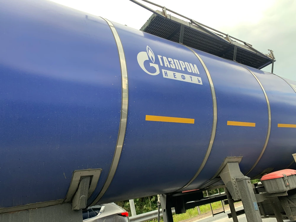 Close-up of Gazprom Neft truck. Translation of a sign in Russian means Gazprom Oil. Shutterstock