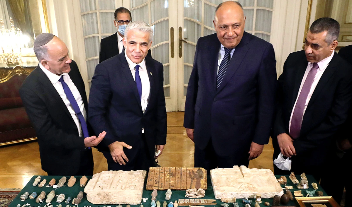 Egyptian Foreign Minister Sameh Shoukry receives stolen Egyptian archaeological items from Israeli Foreign Minister Yair Lapid, that were seized in Israel, at Tahrir Palace in Cairo on Thursday. (Reuters)