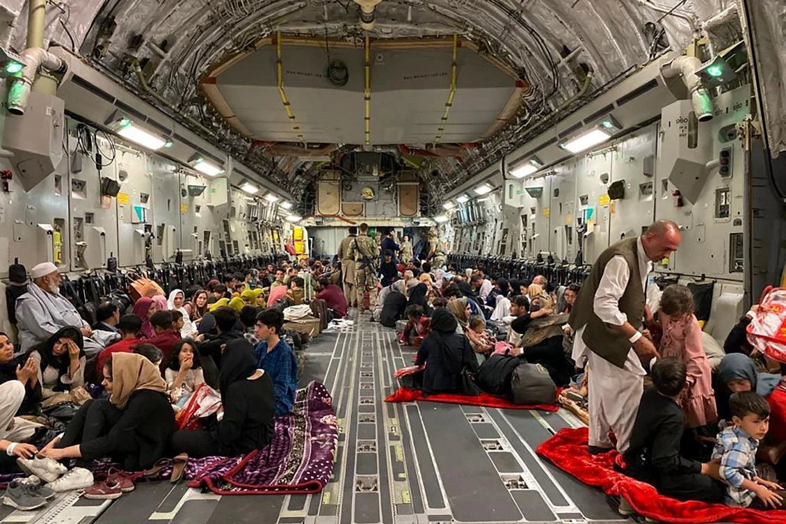 Afghan people sit inside a US military aircraft to leave Afghanistan, at the military airport in Kabul on August 19, 2021 after the Taliban's military takeover of Afghanistan. (AFP)