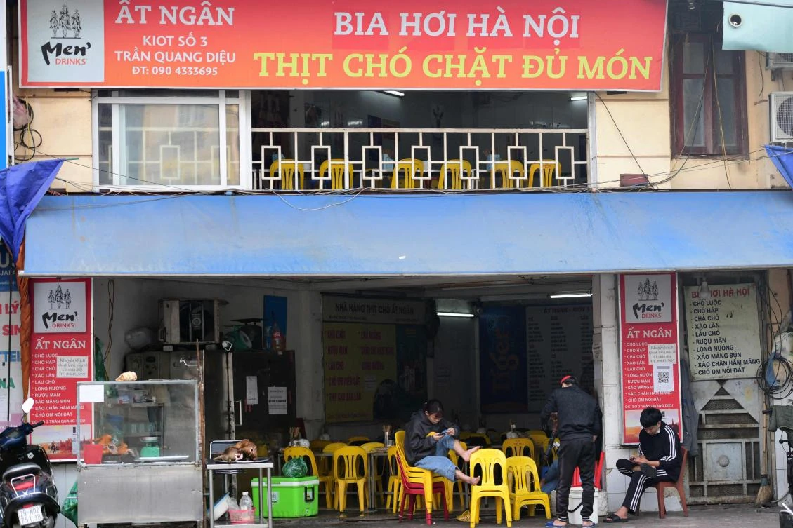 Staff wait for customers at a dog meat restaurant in Hanoi on December 10, 2021, as Vietnamese officials in the central city of Hoi An announced it was set to be the country’s first dog and cat meat free city. (AFP)