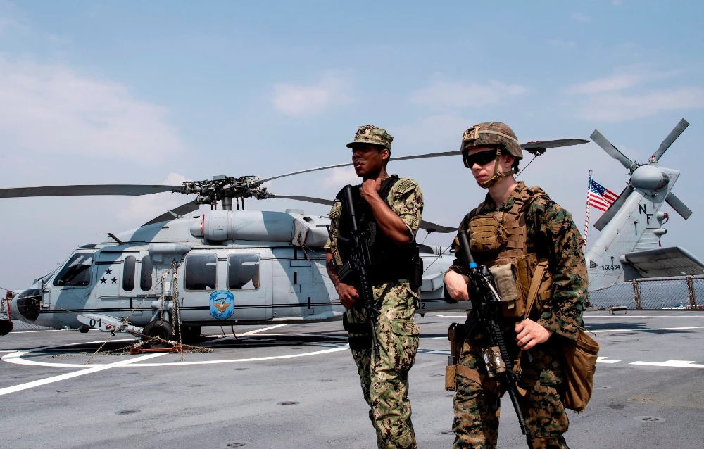US Navy personnel walk past a Sikorsky MH-60 Seahawk helicopter after the USS Blue Ridge docked during a visit in Manila Bay. (AFP file photo)