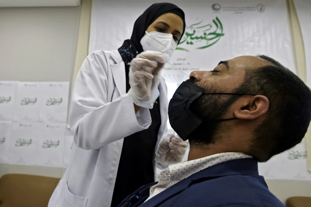 Volunteer medics screen for covid-19 in the Bahraini capital Manama on August 18, 2021. (File/AFP)