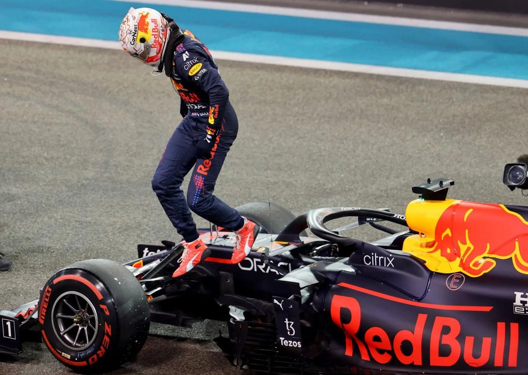 Red Bull’s Dutch driver Max Verstappen leaps from his car after taking pole, during qualifying, for the Abu Dhabi Formula One Grand Prix at Yas Marina Circuit, Dec. 11, 2021. (AFP)