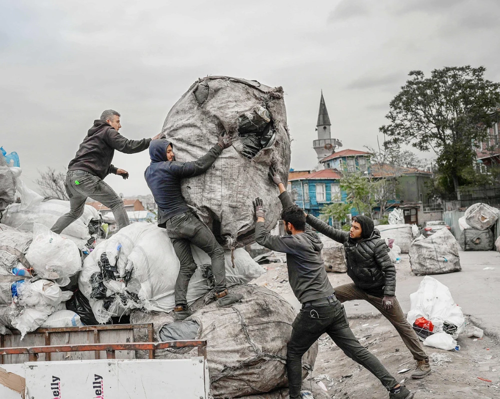 Afghan refugees collect waste at a makeshift dumping ground in Istanbul. (AFP)