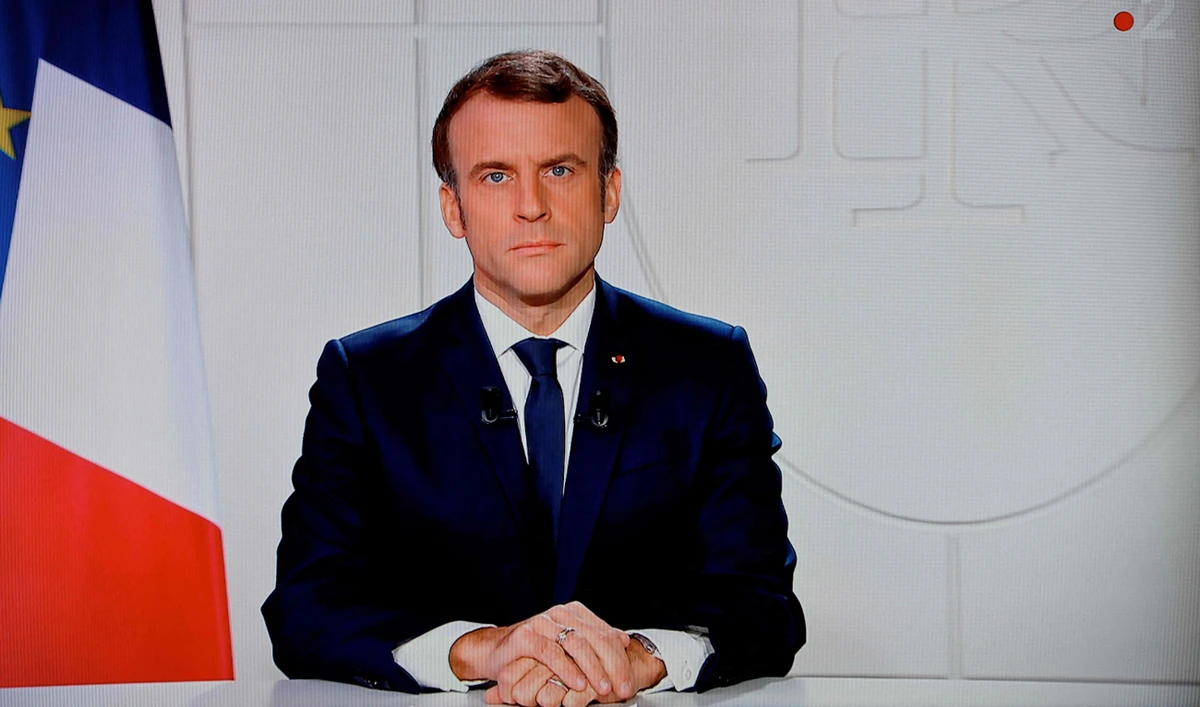 This photograph taken on December 12, 2021, shows French president Emmanuel Macron addresses the nation from TV screen at the Elysee palace, after the third referendum in New Caledonia about it's independance. (AFP)